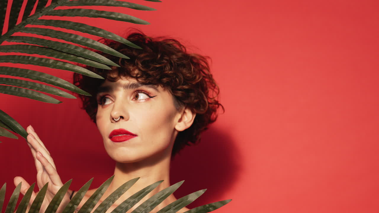 Woman with Curly Hair and Tropical Leaves