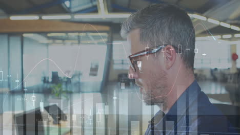 animation of diagrams over caucasian man inspecting camera in office