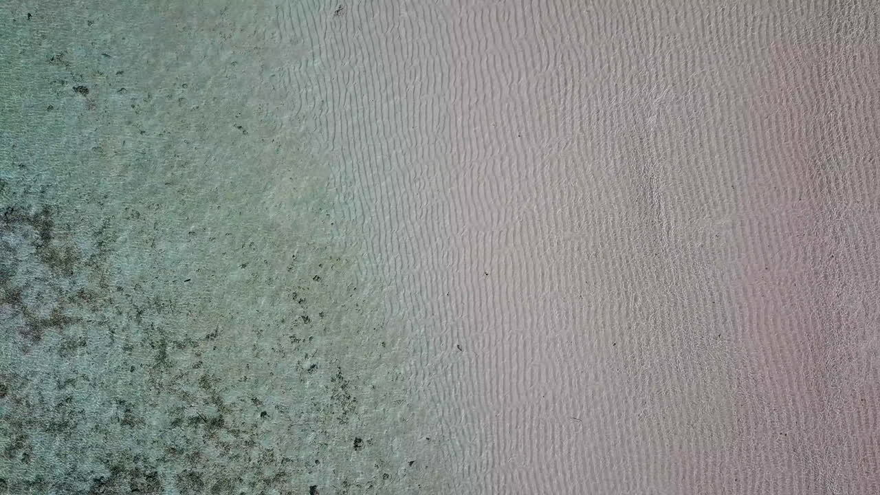 Rising drone shot of shallow and clear ocean waters
