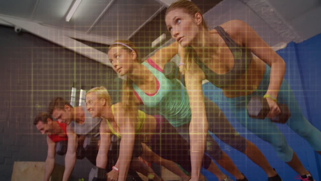 Gym group planking on DBs, right woman leading one-arm rows, following for core grid ECG pulsing