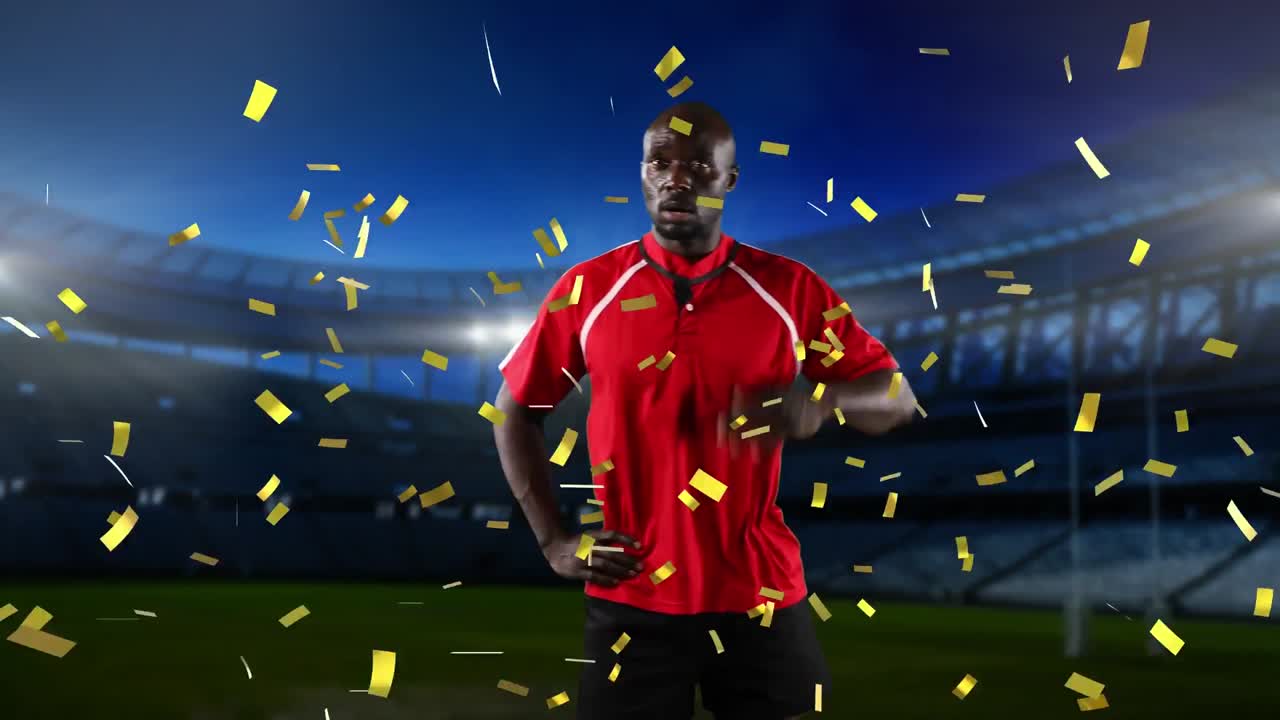 프로 럭비 선수 가 콘페티 가 떨어지는 경기장 앞 에 서 있다