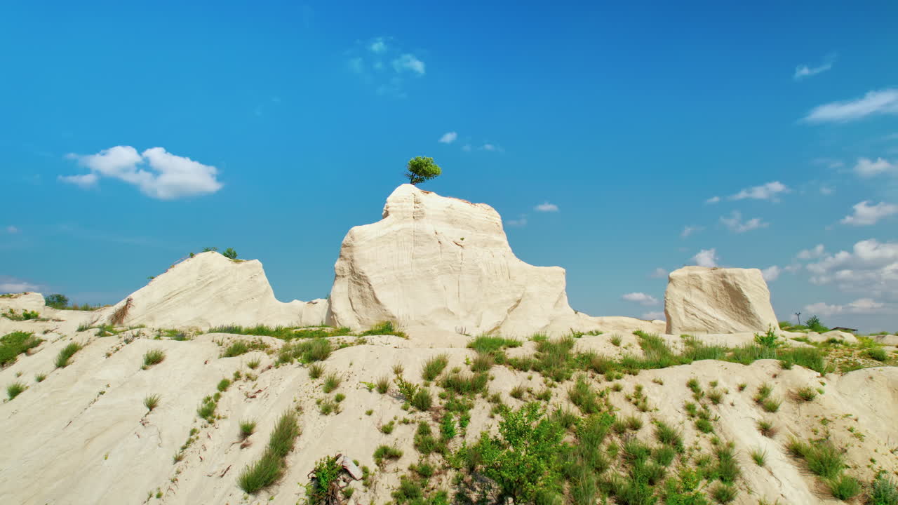 Aerial drone view of the Little Switzerland of Moldova located in Fetesti. Former limestone quarry with unusual landforms. lonely tree on top of a rock