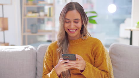 Happy,-woman-and-smartphone-on-couch-in-lounge