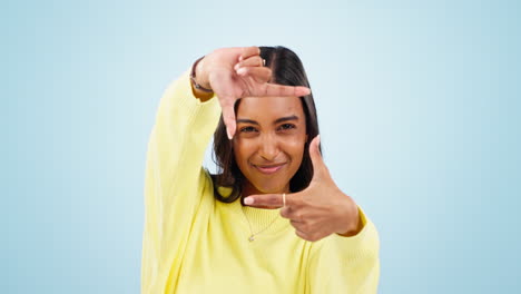 Hands,-frame-and-face-of-woman-in-studio