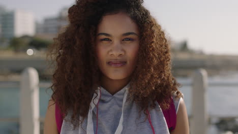 close-up-portrait-of-beautiful-young-mixed-race-woman-looking-serious-pensive-on-beachfront-background