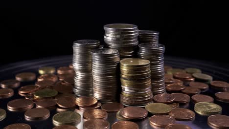 closeup shot of different coins with rotate on black background