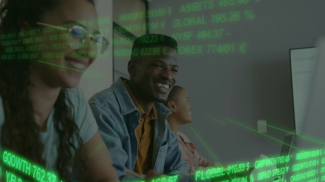 Team sitting at desk facing screen green finance data scrolling typing on tab pen gesturing paper