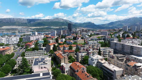 coastal city of split, croatia with dalmatia tower revealed. aerial tilt-up shot