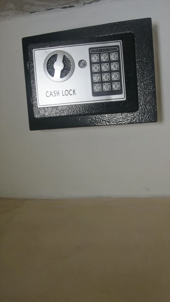 Steel cash lock installed in a wall. Digital lock security. Valuables safe