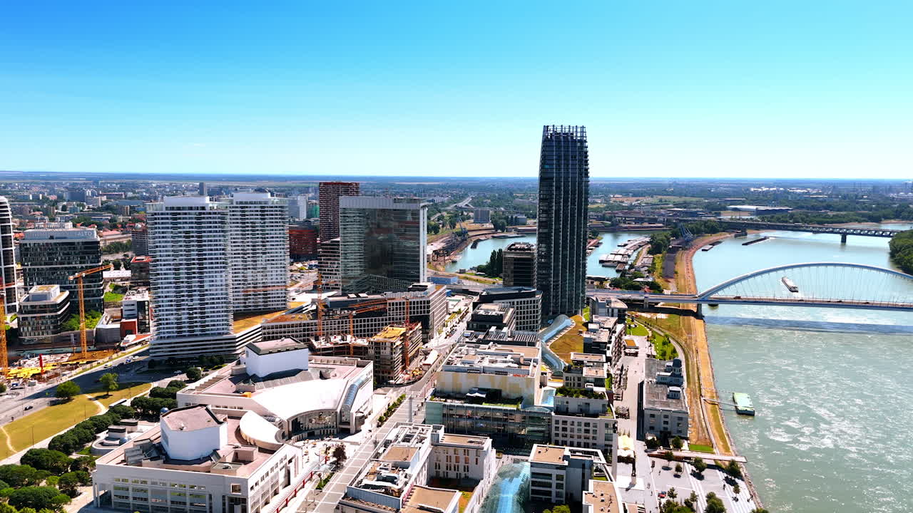 Bratislava skyline and river view. Bright day in Bratislava showcases modern architecture along the waterfront with the Danube River flowing nearby