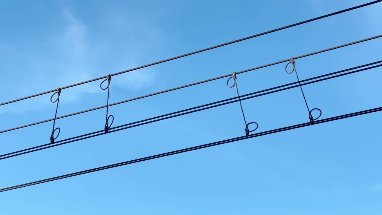 Overhead line catenary and a blue sky