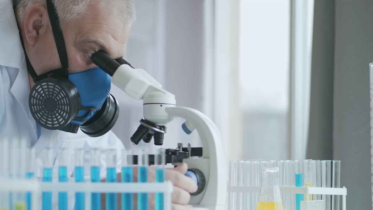 Microbiology Laboratory: Scientist Works with Various Bacteria. Concept of Pharmaceutical Research for Antibiotics Curing Disease with DNA Enhancing Drugs. A man doctor with a microscope. High quality 4k footage