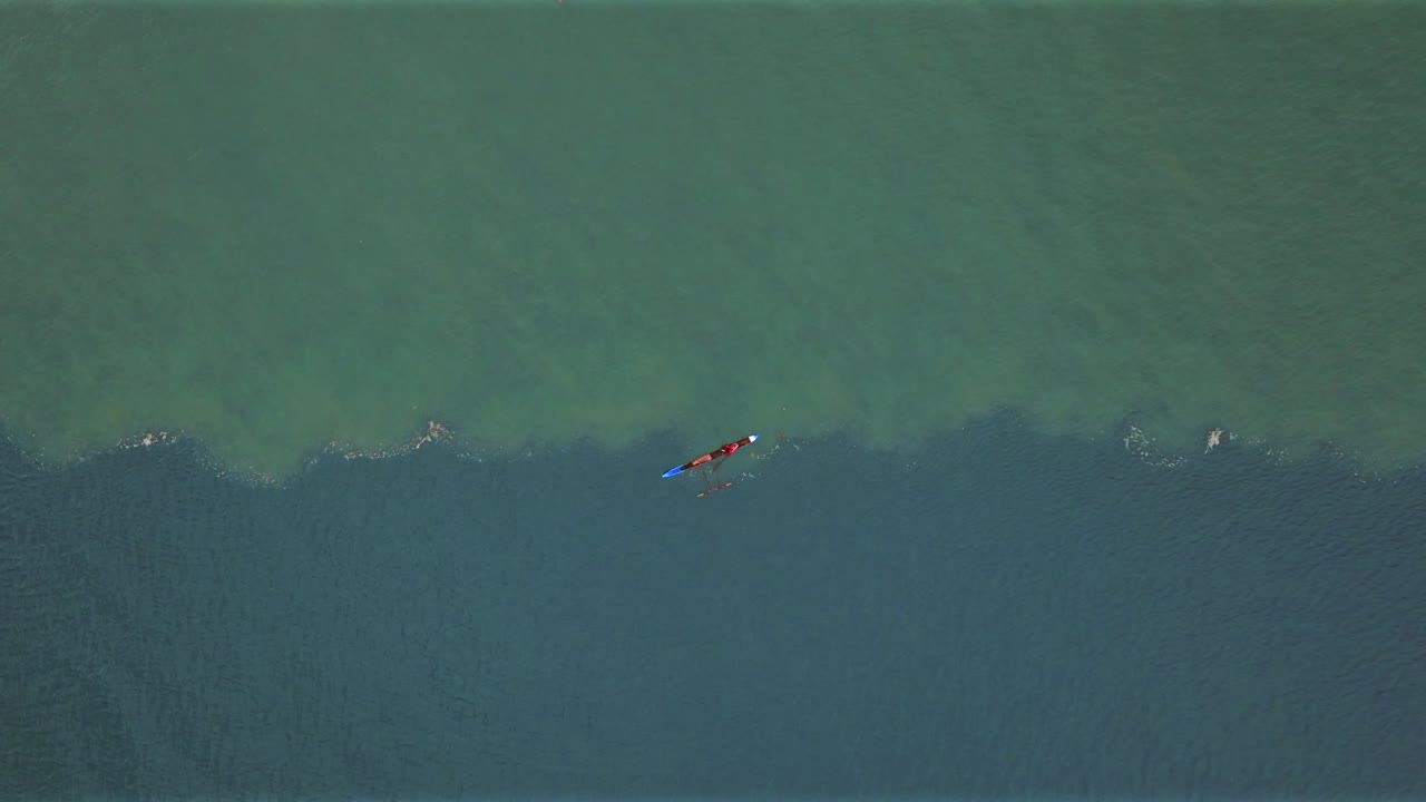 Wewak Papua New Guinea fishing fishermen outrigger canoe sea waves swell current Pacific Ocean morning aerial drone birdseye view Dogreto Bay Cape Wom tropical island coastline East Sepik