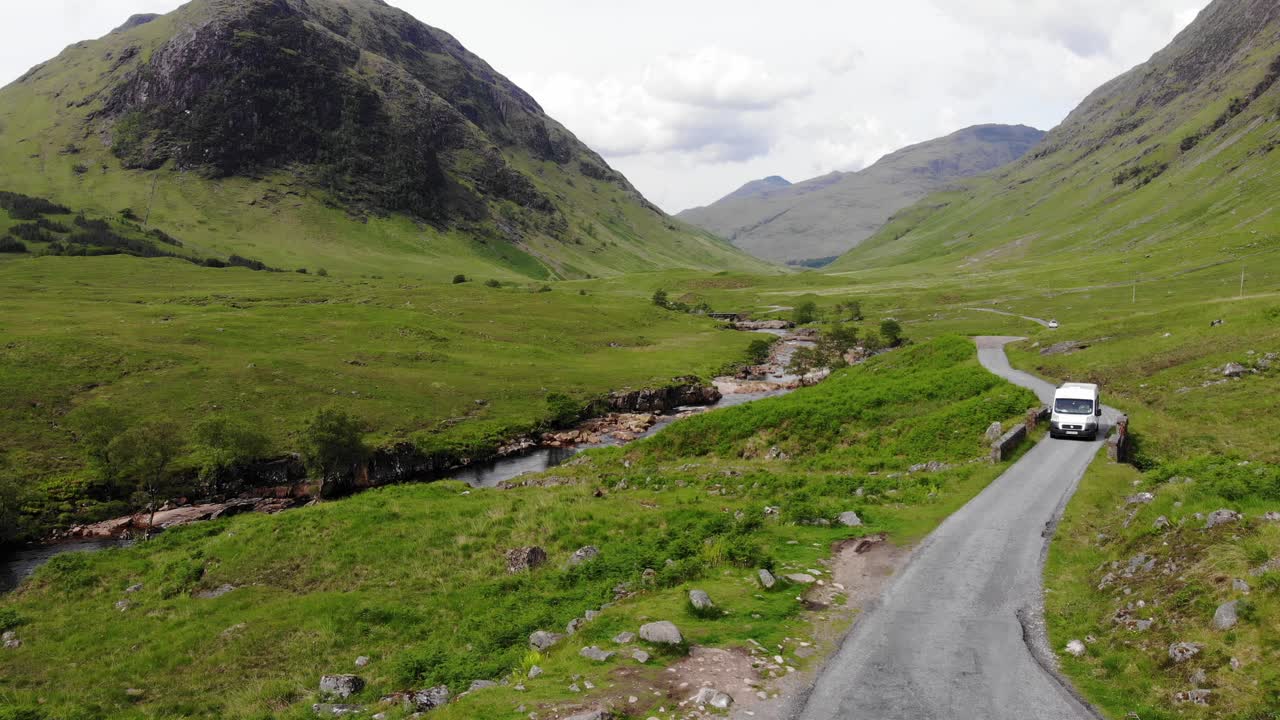 Drone footage alongside River Etive unnamed road near Dalness. Annonymous vehicles driving small road in Scottish Highlands, near Glencoe