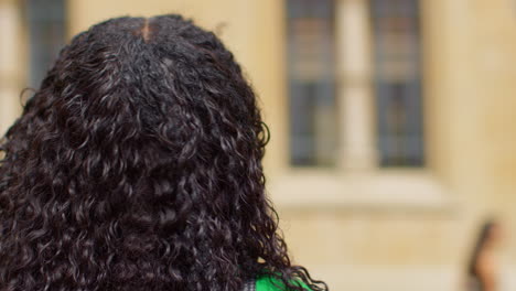 Close-Up-Shot-Of-Female-Tourist-On-Vacation-In-Oxford-UK-Exploring-City-Walking-Along-Broad-Street-2