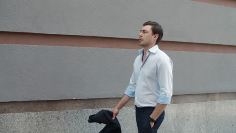 closeup businessman stretching neck outdoor. man walking after work at street.