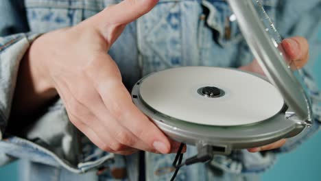 woman loading a portable cd player