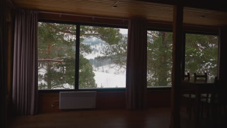 Big panoramic window with view of scenic mountains and trees