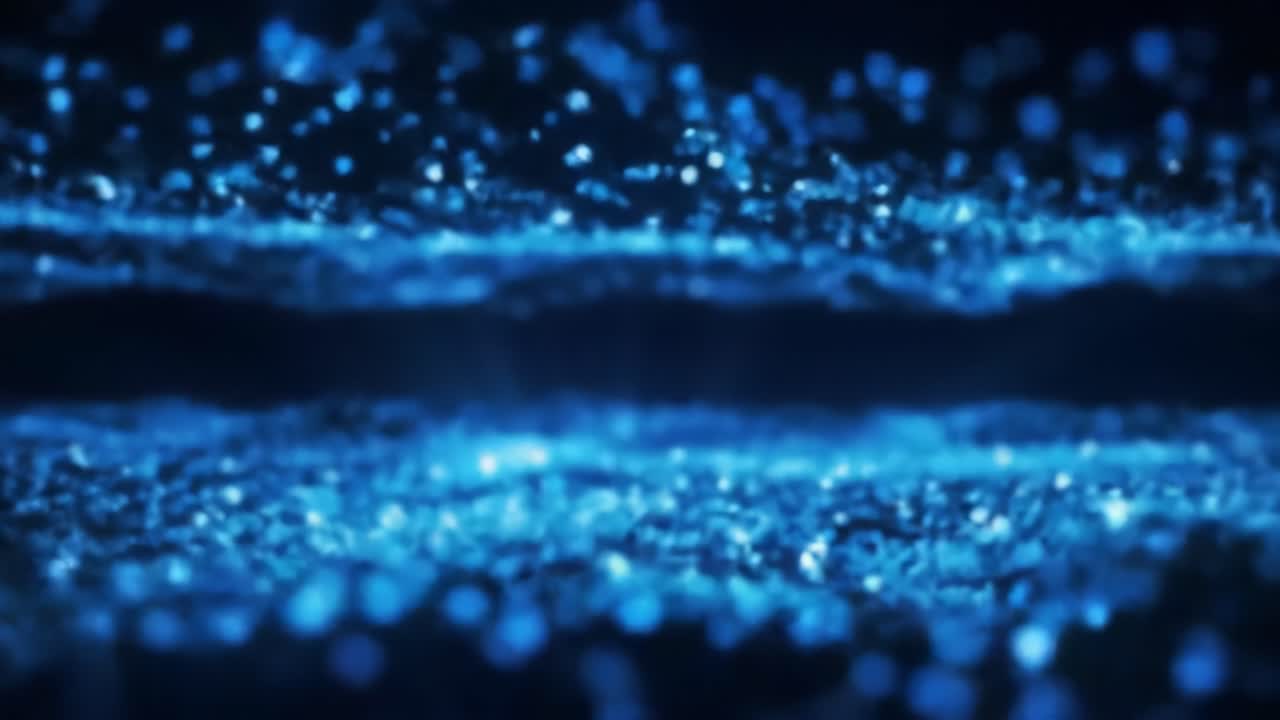 Watch as vibrant blue particles move gracefully, creating a stunning display of light and motion. This captivating visual experience showcases the beauty of flowing energy in a dark setting.