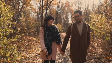 couple walking in autumn forest