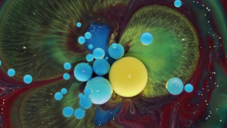 colorful bubbles. abstract yellow, red, blue, green mixture on a black background. artistic color paint background.