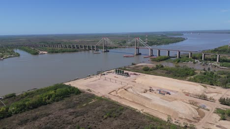 aerial view of a cable-stayed bridge under construction over a wide river
