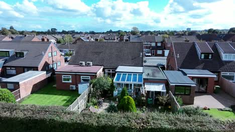 british suburban retirement village homes in row aerial view across typical landscaped back gardens