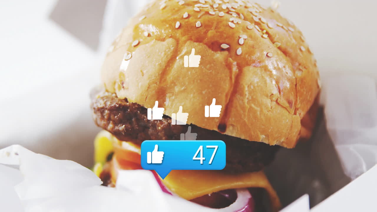 Cheeseburger with animated social media likes overlaying in restaurant setting