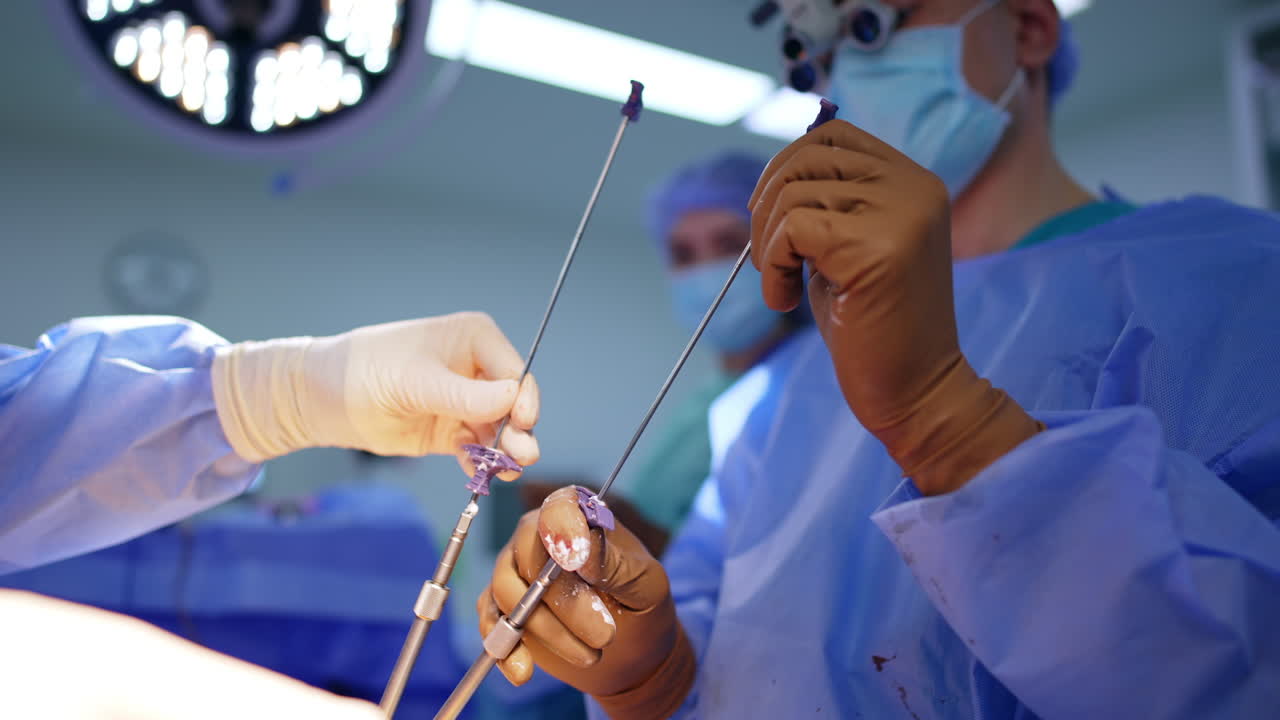 Hands of surgeons with surgical instruments in neurosurgery. Close up of medical professionals holding surgical tools during delicate operation. The procedure demonstrates precision and teamwork