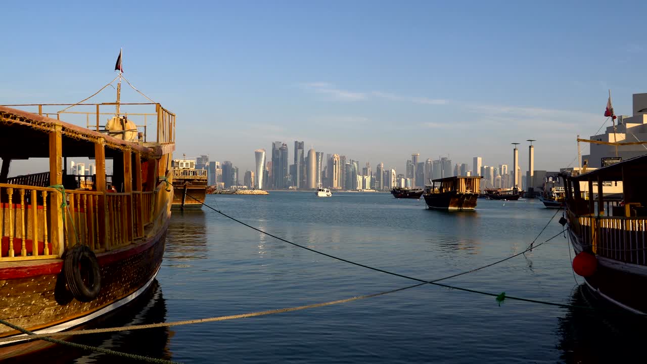 Doha Modern City Skyline Day Shot, Qatar, Middle East. View on Doha Skyscrapers with Traditional Wooden Qatar Boats at Corniche Broadway