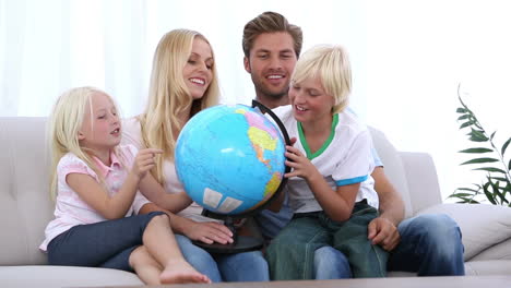 family looking at globe together