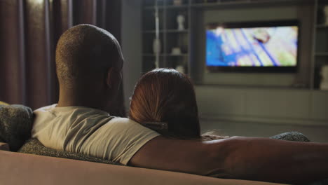 couple watching tv at home