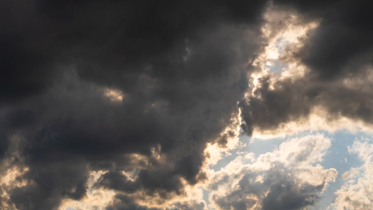 Cloud movement reveals sun rays with clearing stormy weather
