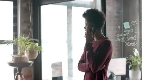 african american casual businessman talking on smartphone at home office, slow motion, copy space