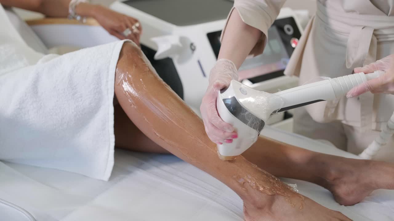Hair removal cosmetology procedure from a therapist at cosmetic beauty spa clinic. Laser epilation and cosmetology.