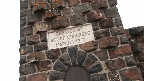 a vintage cornerstone of an old brick building provides information about the creation of yellowstone national park