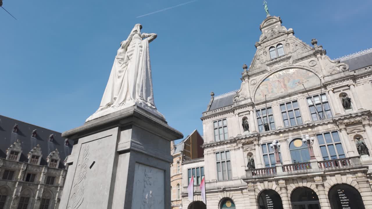 Historic square with Belfry of Ghent and Royal Dutch Theatre under sunny blue sky