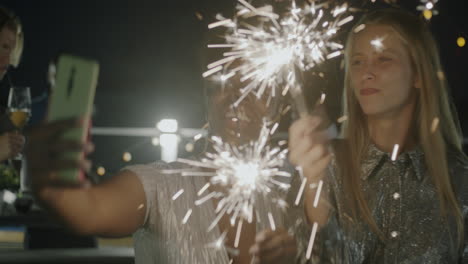 Friends Taking Selfie with Sparkler at Night Party