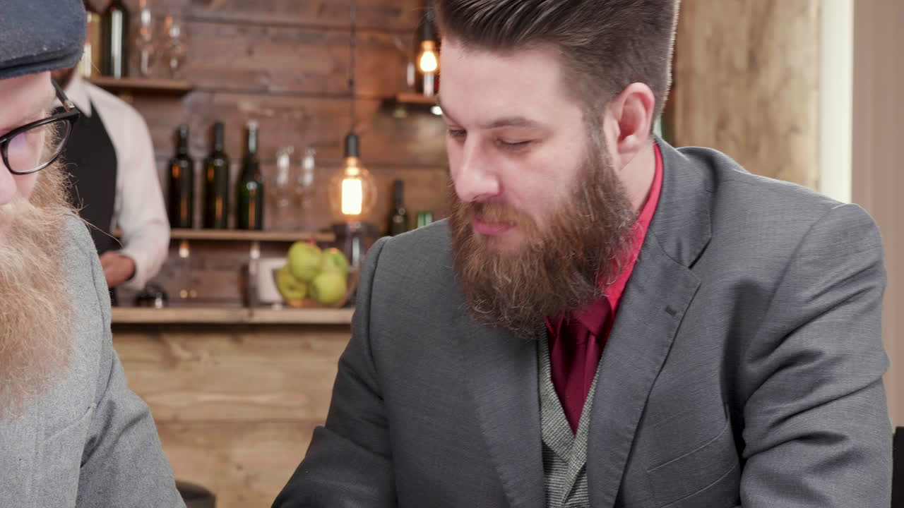 Men in Suits Discussing Business at Bar
