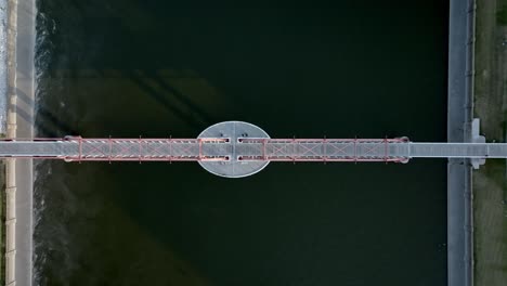 pedestrian bridge over des moines river in downtown des monies, iowa with drone video overhead and moving down