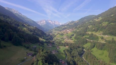 aerial footage over a lush green alpine valley