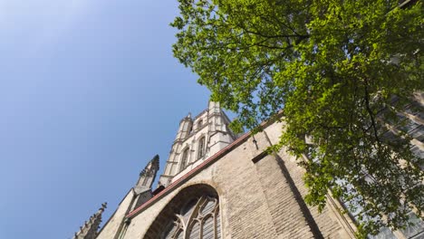 gothic facade of saint bavo's cathedral with towering spires in ghent belgium