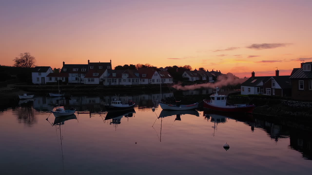 Sunrise over a fishing village harbour