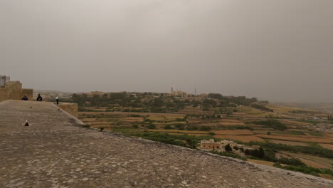 In-A-Cloudy-Weather-Lays-A-Beautiful-Landscape-And-People-Sightseeing-In-Malta