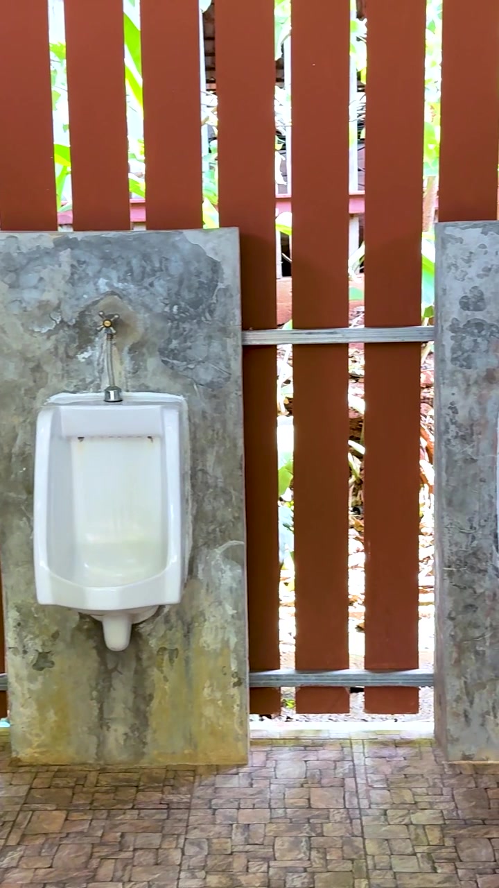 Urinals in a public male restroom setting