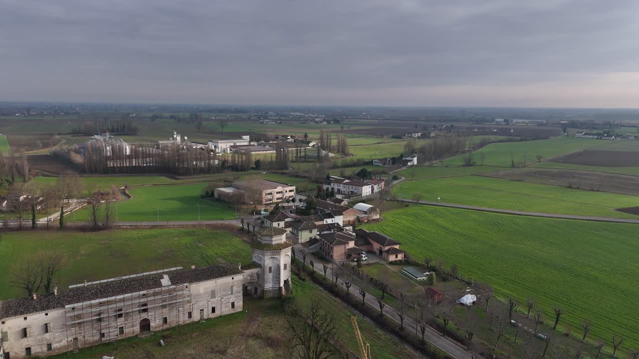 Corte Castiglione, historic Lombard rural court and birthplace of Baldassare Castiglione, seen from above in Casatico di Marcaria, Mantova, Lombardy, Italy, drone pulling out
