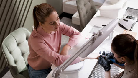 Woman getting her nails done at a nail salon