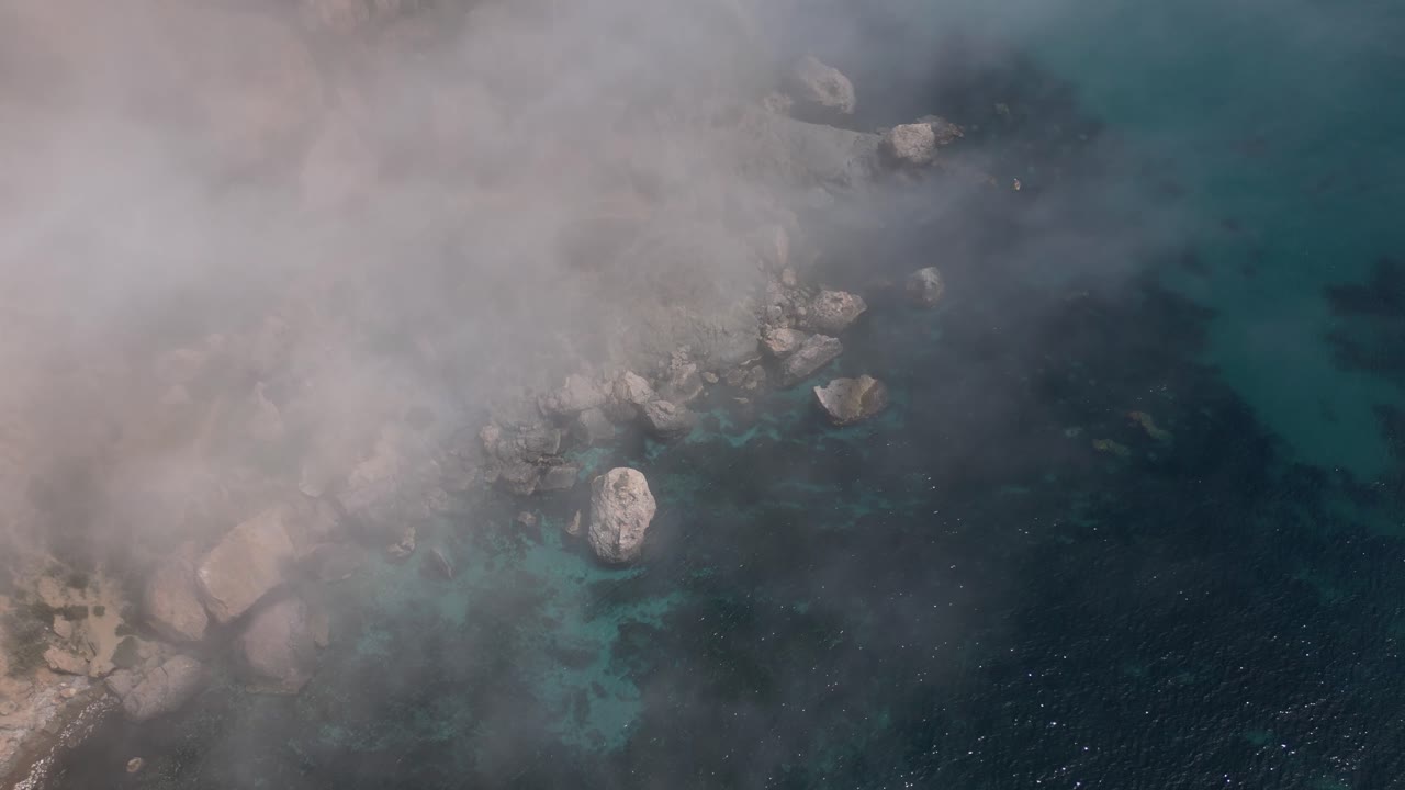 Foggy Coastal Cliffs and Turquoise Sea - Aerial View