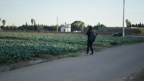 Woman taking a photo in a cabbage field