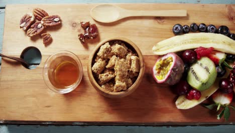 Granola-bars-in-bowl-with-honey-and-fruits-4k